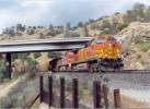 BNSF 5468 East near Woodford. CA hwy 58 is the overpass behind the train