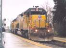 UP 8626 leads a work train from the Yolo Causeway into Davis 1/24/04. The train stopped and the power ran around the train and headed east.